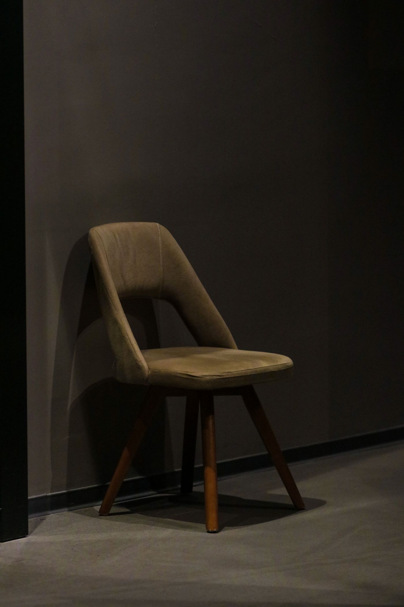 A wooden accent chair in a quiet interior