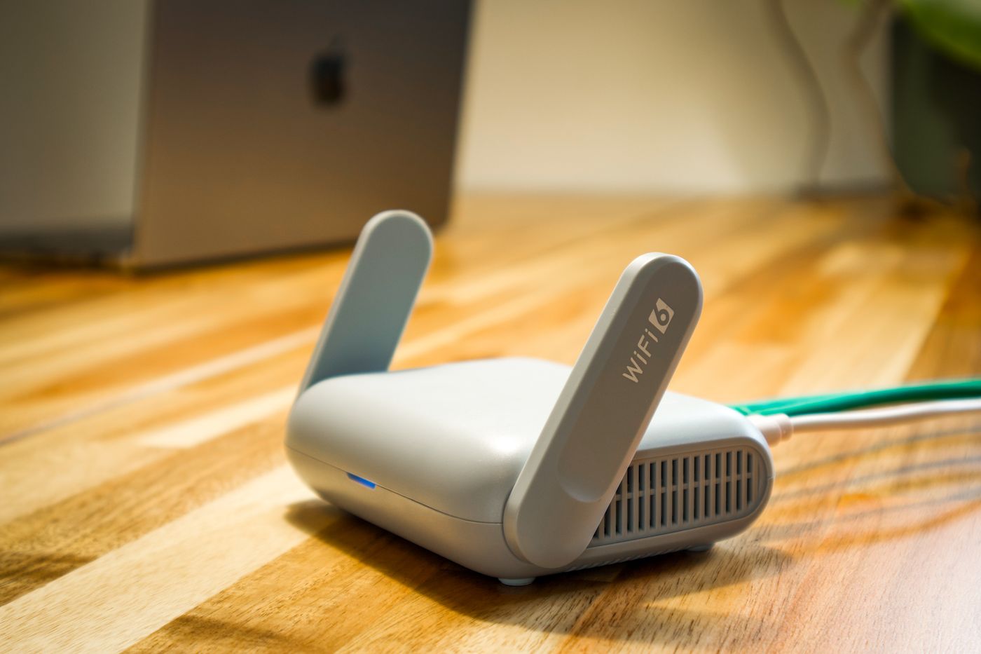 A Wi-Fi router on a wooden desk